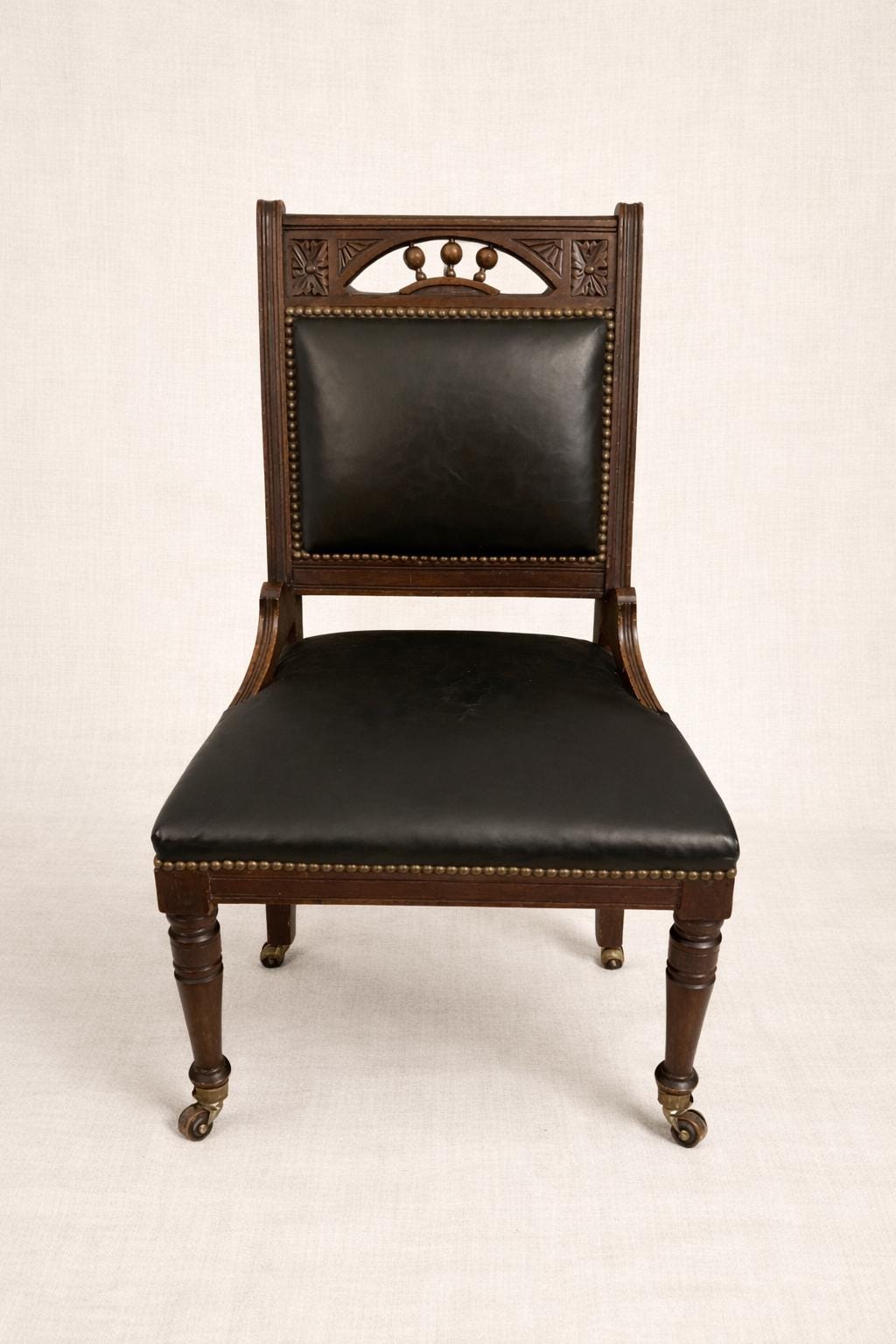 Antique English Leather Library Chair with Wooden Casters | Carved Mahogany Desk or Reading Chair